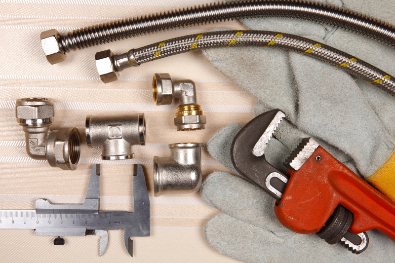 Plumber working on pipes in a Belgravia home